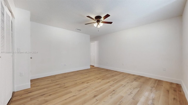 spare room with ceiling fan and light hardwood / wood-style floors