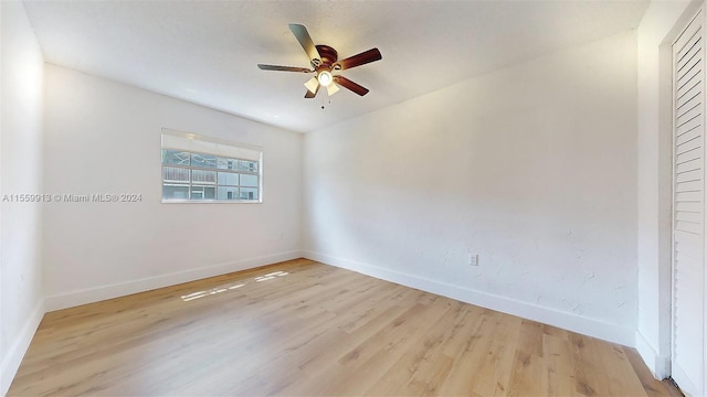 unfurnished room featuring ceiling fan and light wood-type flooring