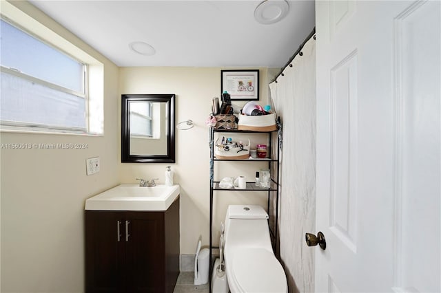 bathroom featuring toilet and vanity