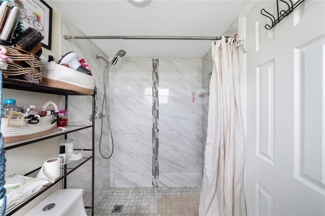 bathroom with a shower with curtain and toilet