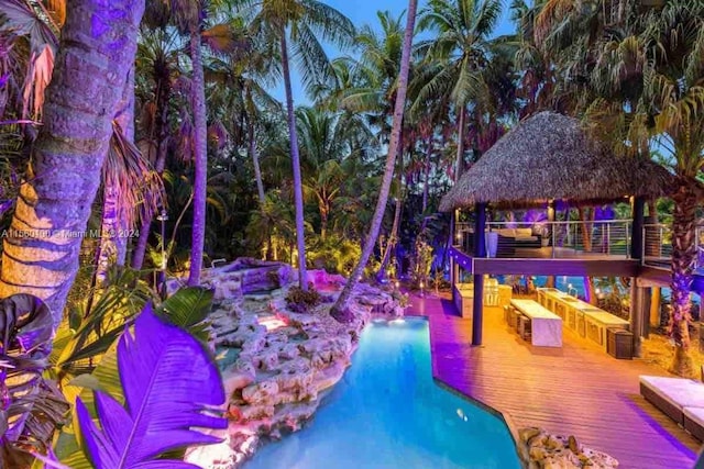 view of pool featuring a deck, central AC, and a gazebo