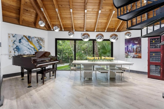 dining room featuring wood ceiling, hardwood / wood-style floors, beamed ceiling, and high vaulted ceiling