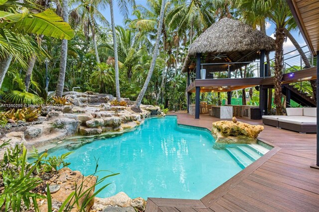 view of pool with a gazebo and a wooden deck