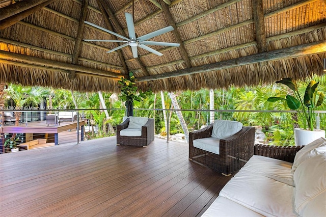 wooden terrace featuring a gazebo and ceiling fan