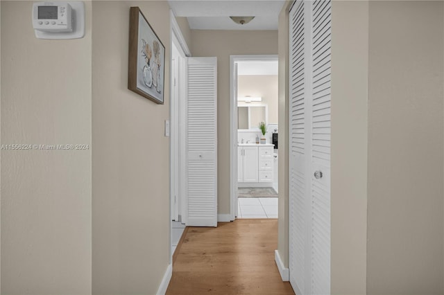 corridor with light hardwood / wood-style floors