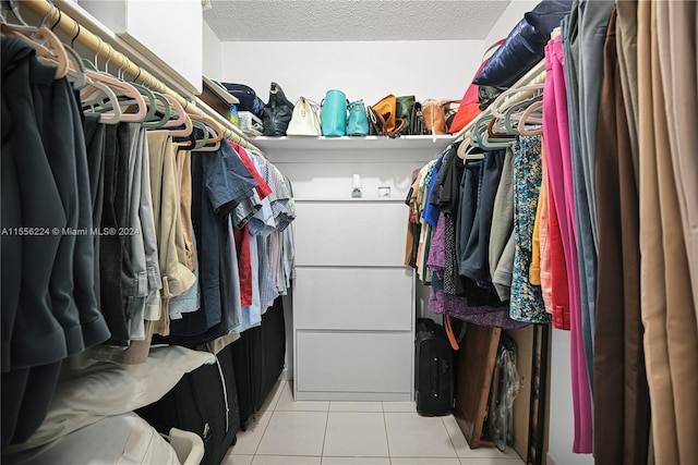 spacious closet with light tile patterned floors