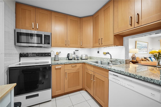 kitchen featuring light tile patterned flooring, tasteful backsplash, and white appliances