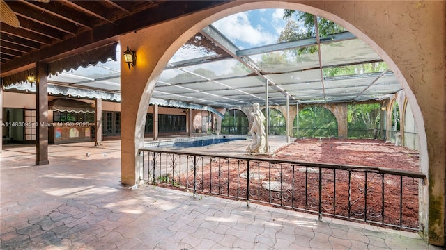 view of patio featuring glass enclosure and an outdoor pool