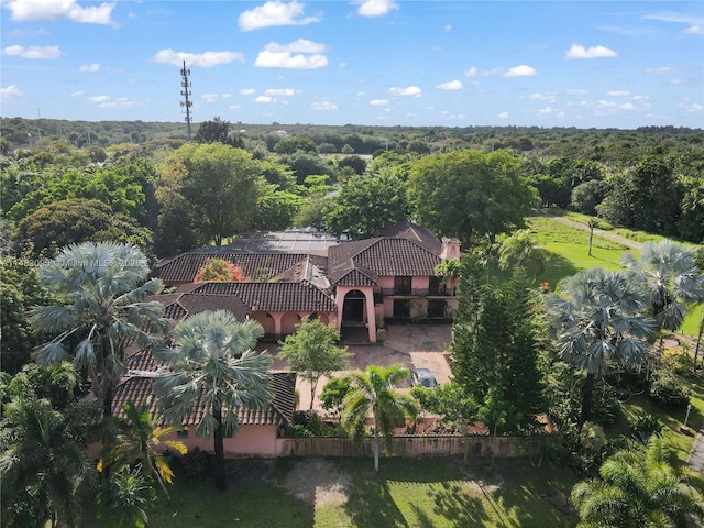 birds eye view of property featuring a view of trees