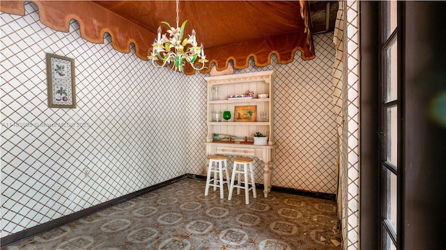 interior space with wallpapered walls and baseboards