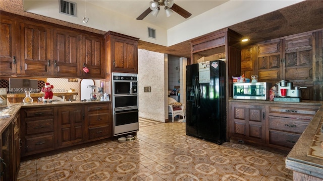 kitchen featuring dark brown cabinetry, visible vents, stainless steel microwave, and black fridge with ice dispenser