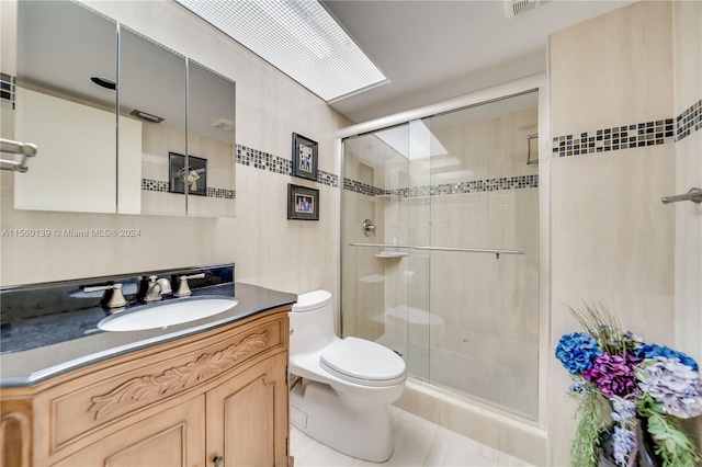 bathroom with toilet, oversized vanity, tile walls, tile flooring, and an enclosed shower