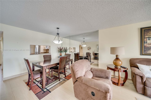 dining area featuring a textured ceiling