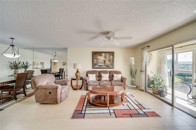 tiled living room with a textured ceiling and ceiling fan