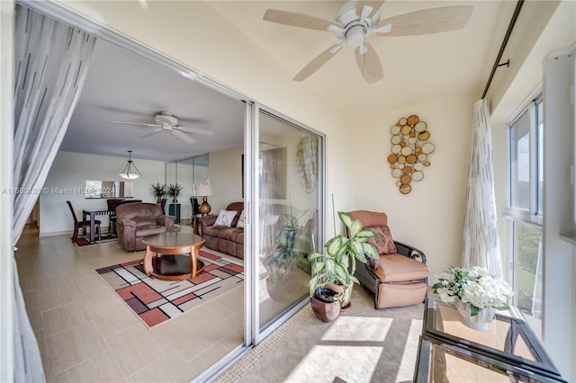 sunroom / solarium featuring ceiling fan