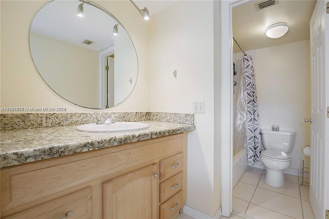 full bathroom with tile flooring, shower / tub combo with curtain, toilet, and vanity