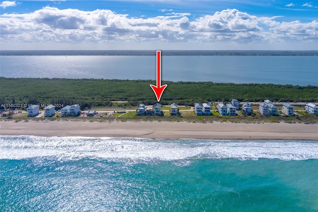 drone / aerial view featuring a view of the beach and a water view