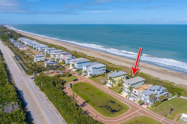 birds eye view of property featuring a view of the beach and a water view