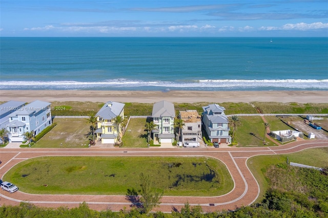 birds eye view of property with a view of the beach and a water view