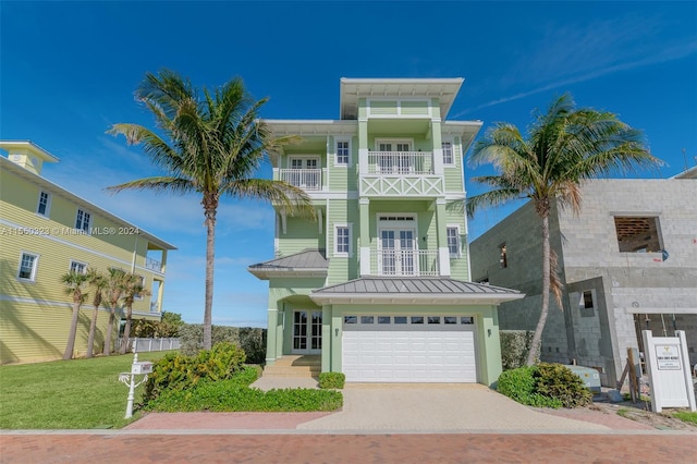 view of front facade with a balcony, a garage, and a front lawn