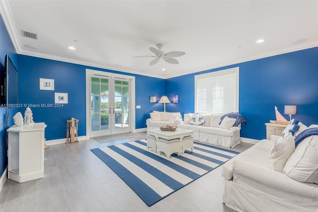 living room with ornamental molding, french doors, light hardwood / wood-style flooring, and ceiling fan