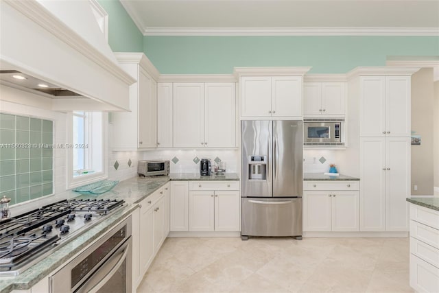 kitchen featuring light stone countertops, stainless steel appliances, custom range hood, and white cabinetry