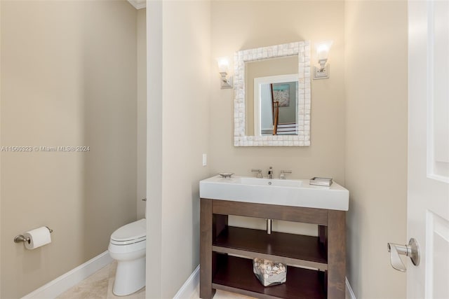 bathroom featuring tile patterned floors, toilet, and vanity