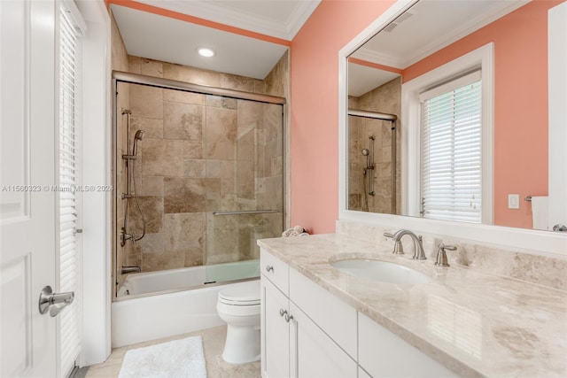 full bathroom with tile patterned flooring, crown molding, toilet, bath / shower combo with glass door, and vanity