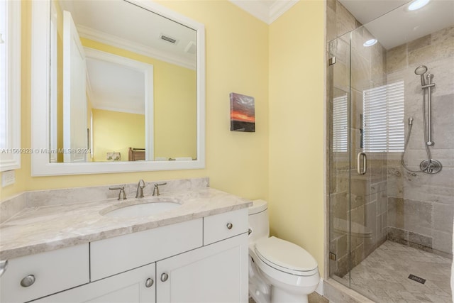 bathroom featuring vanity, toilet, ornamental molding, and an enclosed shower