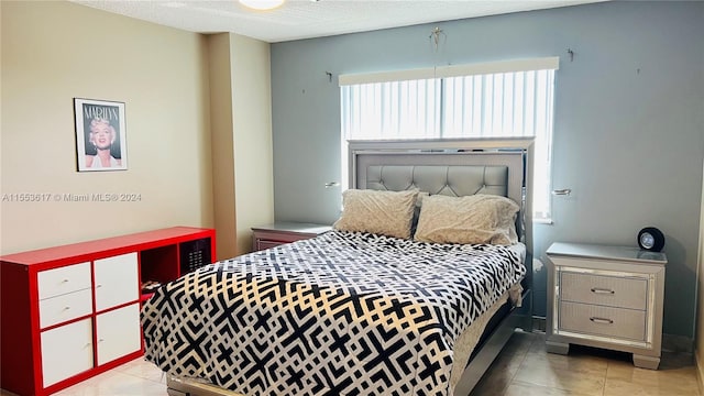 tiled bedroom featuring a textured ceiling