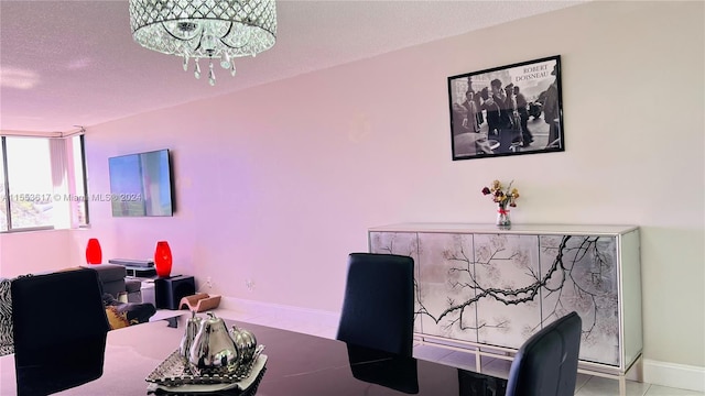 office area with a notable chandelier, light tile floors, and a textured ceiling