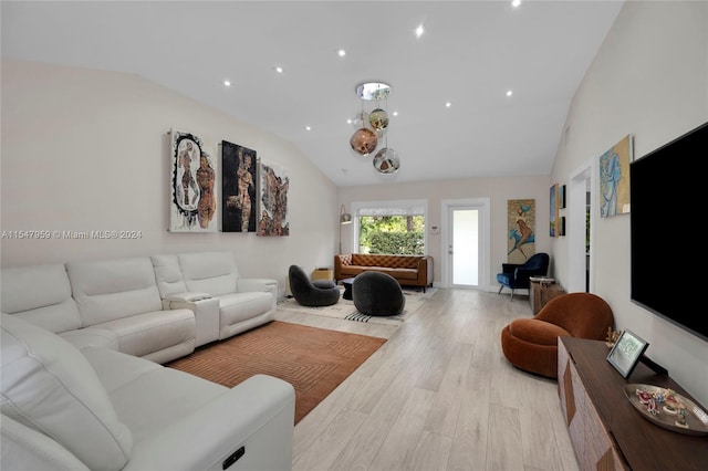 living room with vaulted ceiling and light hardwood / wood-style floors