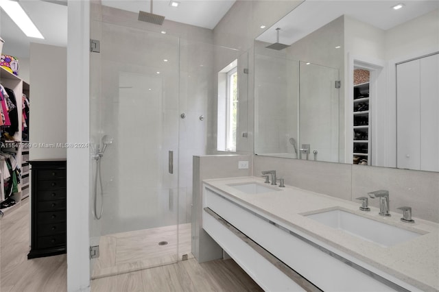 bathroom with walk in shower and double sink vanity