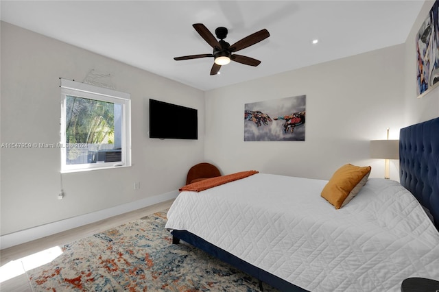 bedroom with light hardwood / wood-style floors and ceiling fan