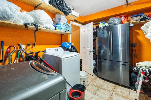 washroom featuring washer / clothes dryer and light tile floors