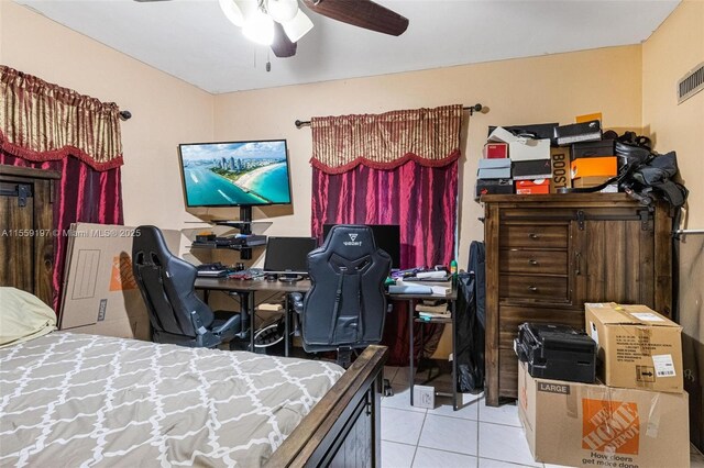 bedroom with ceiling fan and light tile floors