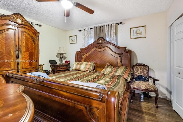 bedroom with dark hardwood / wood-style floors, a textured ceiling, a closet, and ceiling fan