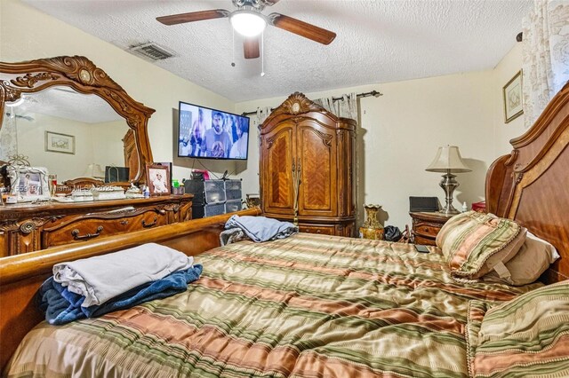 bedroom with a textured ceiling and ceiling fan