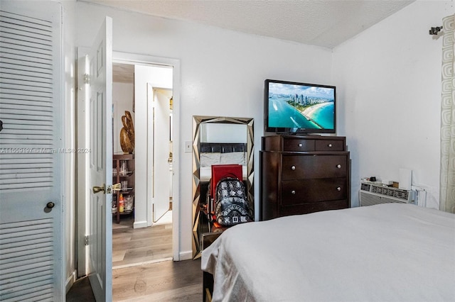 bedroom featuring a textured ceiling and hardwood / wood-style flooring