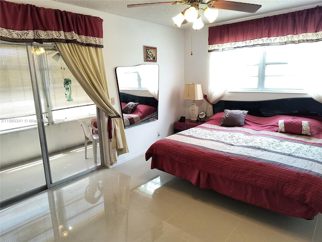 tiled bedroom featuring ceiling fan and a textured ceiling