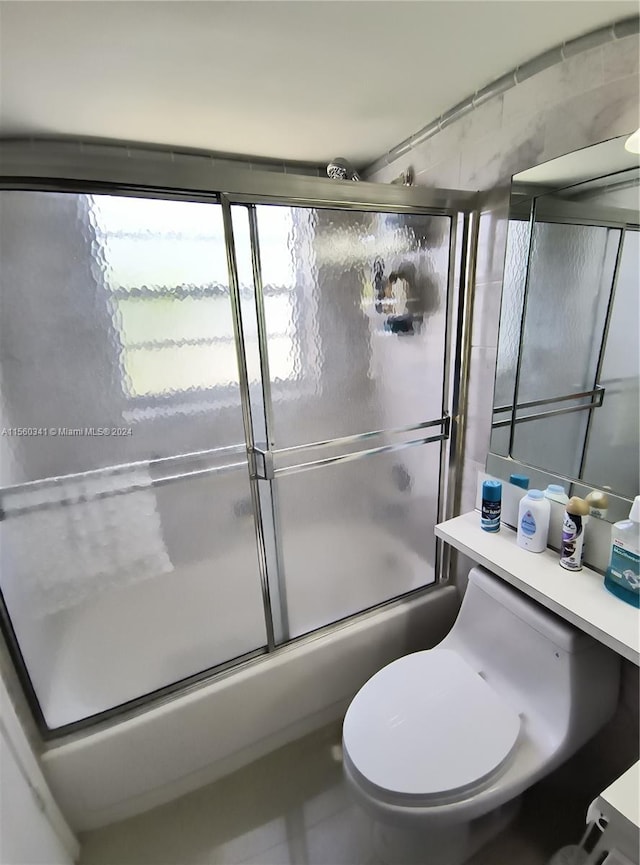 full bathroom with vanity, shower / bath combination with glass door, and toilet