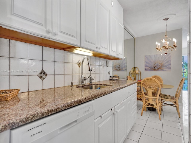 kitchen featuring sink, white dishwasher, white cabinets, and tasteful backsplash