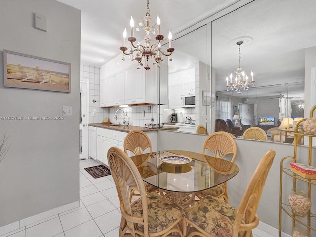 dining space with a notable chandelier and light tile patterned flooring