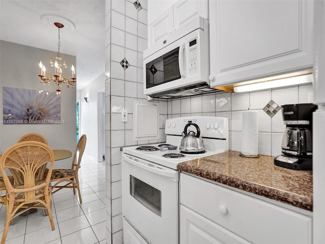 kitchen featuring light tile patterned floors, white cabinets, tile walls, and white appliances