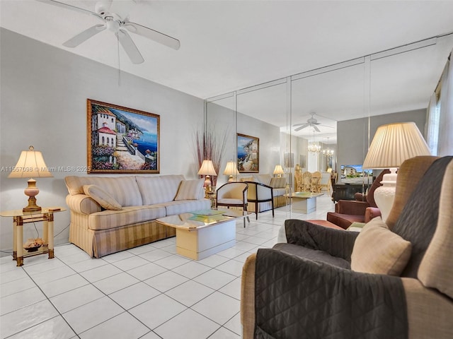 living area with ceiling fan with notable chandelier and light tile patterned floors