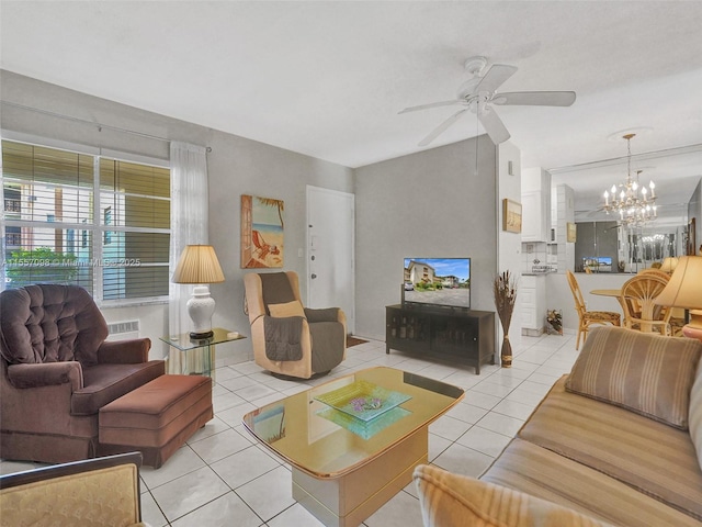 living room featuring ceiling fan with notable chandelier and tile patterned floors