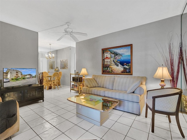 living area with ceiling fan with notable chandelier and light tile patterned floors