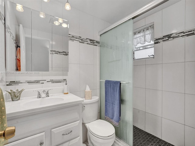 full bath with tile walls, tasteful backsplash, toilet, a stall shower, and vanity