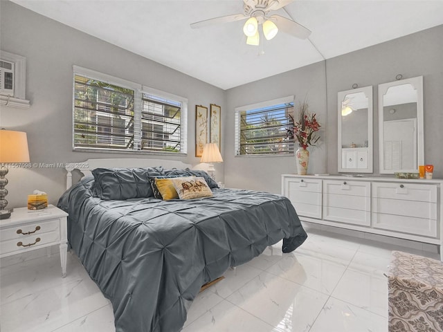 bedroom featuring ceiling fan and marble finish floor