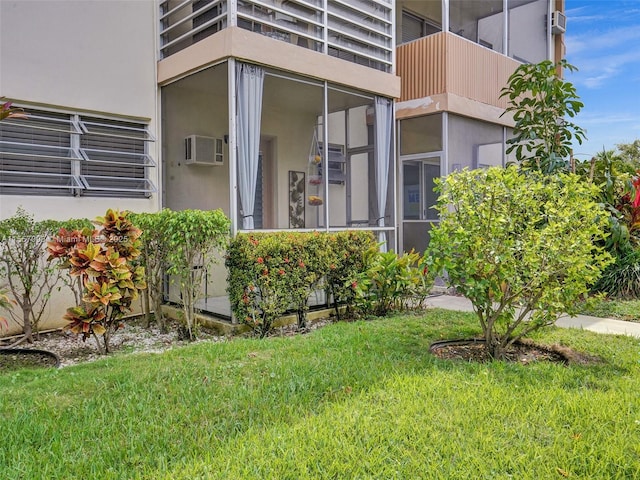 property entrance with a lawn and stucco siding